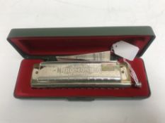 A Hohner super chromonica, boxed with instructions.