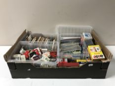 A box of a quantity of assorted playing cards together with a collection of matchbooks,