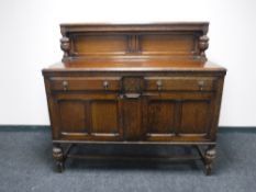 An early 20th century oak buffet back sideboard