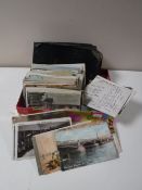 A quantity of early 20th century postcards together with an album