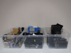 Three boxes containing various camera accessories, flash lights, developing equipment etc.