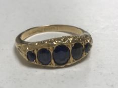 An 18ct gold five stone sapphire ring, size K, 2.9g.