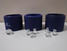 Three boxed Swarovski Crystal animals - hedgehog and two x 3 penguins on ice bergs