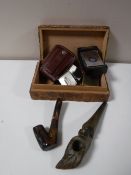 A carved wooden lidded cigarette box containing a Zippo 