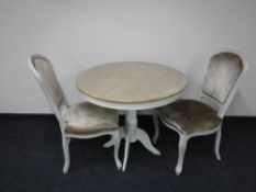 A contemporary French shabby chic table with two chairs