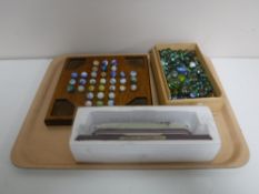 A marble solitaire game on wooden board,