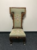 A 19th century French carved walnut and embroidered chaise de priere, height 104cm.