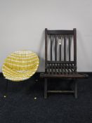 A mid 20th century child's wicker chair and a teak folding garden chair