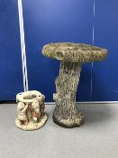 A pedestal bird bath and a gnome planter