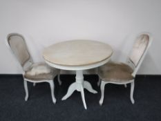 A contemporary French shabby chic table with two chairs