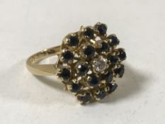 An 18ct gold sapphire and diamond cluster ring, 7.