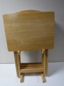 Four folding pine occasional tables on stand