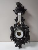 A Black Forest carved oak barometer