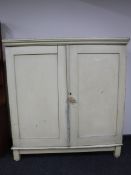A painted pine double door kitchen cupboard on stand