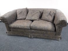 A contemporary two seater settee upholstered in hieroglyphic fabric,