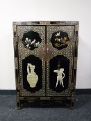 A Chinese lacquered double door cabinet