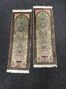A pair of Indian Kashmir silk finished rugs, of floral design on green ground.