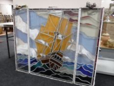 Three piece leaded stained glass window depicting a ship at full sail