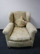 A Victorian style wingback armchair upholstered in a floral fabric, width 92cm.