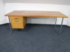 A mid 20th century teak single pedestal desk fitted two drawers