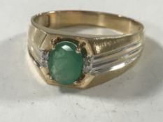 A 14ct gold emerald and diamond ring