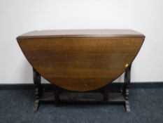 An oak drop leaf table, length opened 136cm.