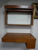 A teak Ladderax style writing desk fitted bookcase and light above