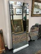 An all glass bevelled mirror,