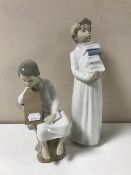 A Lladro figure of a seated boy reading together with a Nao figure of a boy carrying books