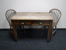 An early 20th century oak desk fitted two drawers together with two Windsor dining chairs