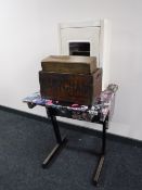 A 20th century school desk decorated with pictures of 80's rock stars together with a metal wall