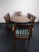 An inlaid mahogany Regency style extending dining table with leaf together with six chairs
