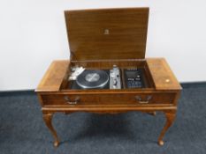 A Dynatron stereo system in figured walnut table together with similar record cabinet and TV