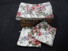 A box containing a floral quilt together with a pair of matching floral curtains