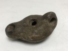 A Roman pottery oil lamp, Capri 2nd-3rd century AD, length 8 cm.