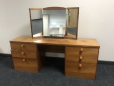 A Stag six drawer dressing table with triple mirror and stool and a pair of bedside stands