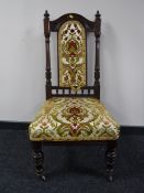 A late Victorian carved mahogany bedroom chair upholstered in a floral brocade