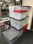 A quantity of plastic storage crates with lids