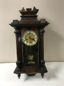 A mahogany cased eight day wall clock with brass and enamelled dial