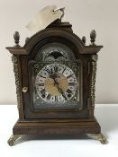 A Wuba moonphase mantel clock with metal mounts