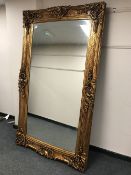 A 19th century style gilded rectangular mirror, 213 cm x 125 cm.