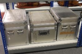 Three aluminium flight cases.