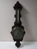 An early 20th century carved oak cased barometer by F.