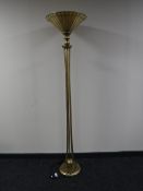 A contemporary metal uplighter with a leaded glass shade together with a matching table lamp