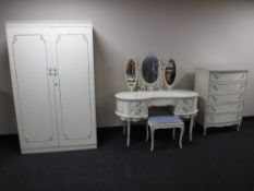 A cream and gilt four piece bedroom suite comprising of double door wardrobe,