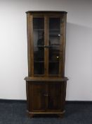 An oak corner display cabinet