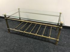 A brass glass topped coffee table with undershelf