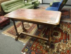 A late 19th century oak library table with red leather top,