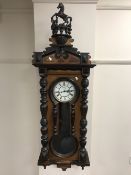 A 19th century mahogany cased Vienna wall clock with carved horse pediment.