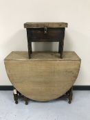 An oak barley twist drop leaf table together with an early twentieth century storage cracket stool